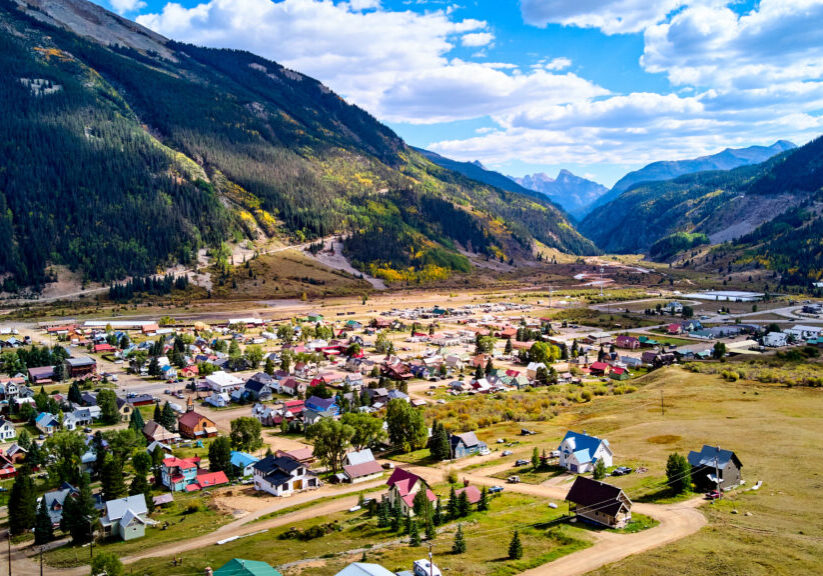 Image of View above of small mining town in valley with background of large mountain ranges